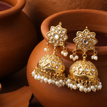 Gold-tone Mehrunisa jhumka earrings with floral tops, clear reflective accents and dangling white bead fringes